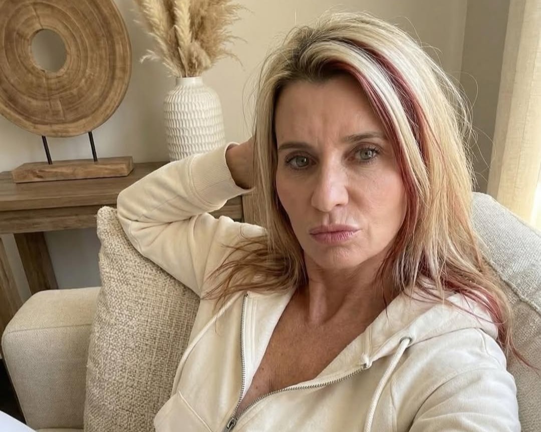 Amanda Dalton wearing lounge wear at her living room couch